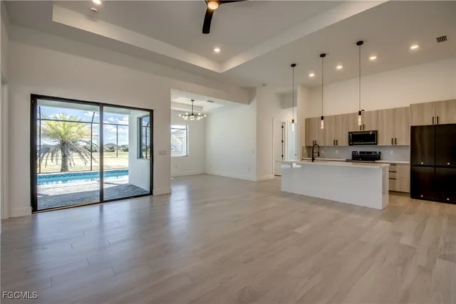 a large kitchen with cabinets and wooden floor