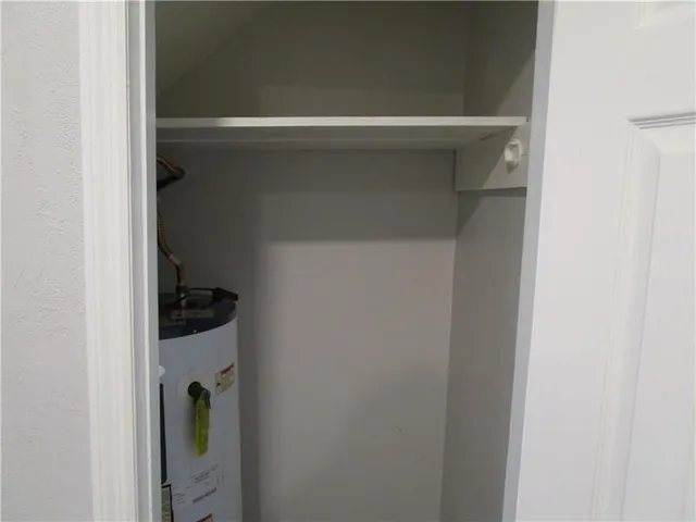 a close view of walk in closet with clothes