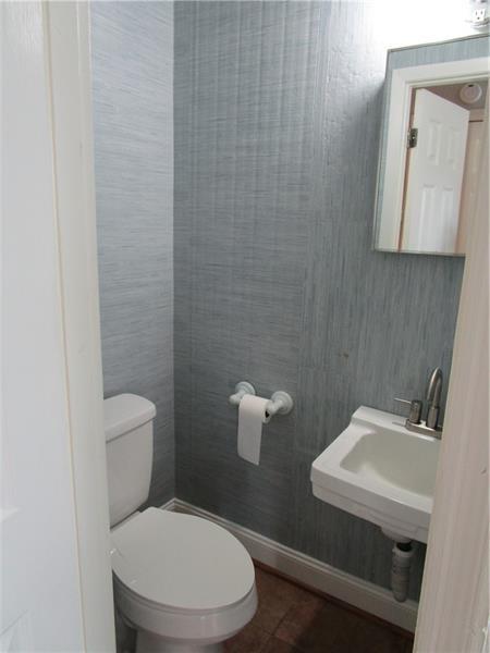1235 Riverside Drive, Unit F6 Gainesville, GA 30501 - Photo 18 of 38 a bathroom with a toilet a sink and mirror