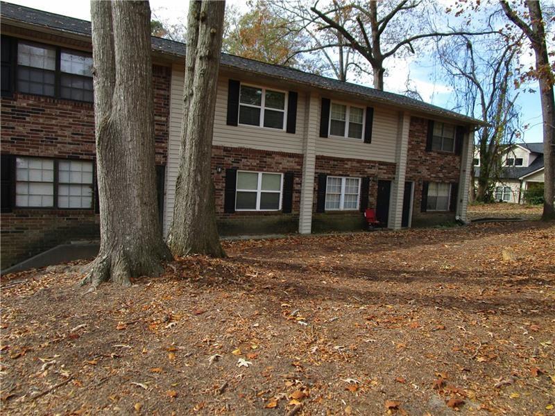 1235 Riverside Drive, Unit F6 Gainesville, GA 30501 - Photo 2 of 38 a front view of a house with a yard