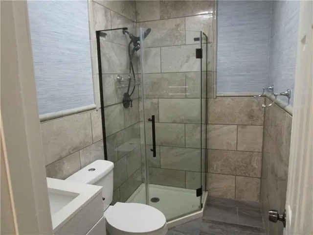a bathroom with a toilet and a shower