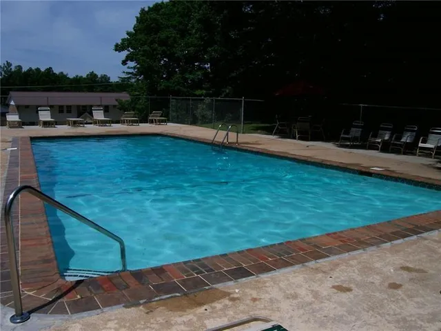 a view of a swimming pool with a patio