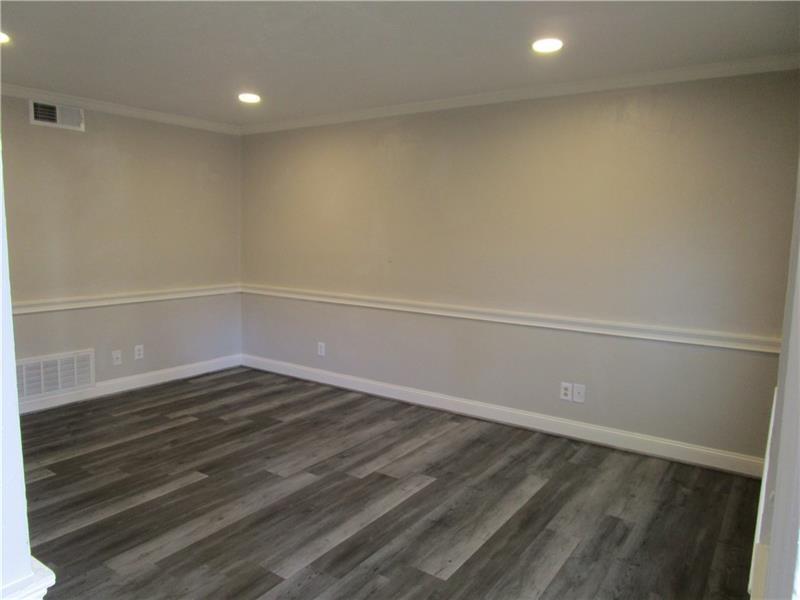 1235 Riverside Drive, Unit F6 Gainesville, GA 30501 - Photo 5 of 38 a view of an empty room with wooden floor and a window