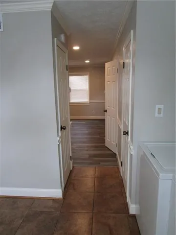 a view of a hallway with a storage & utility room