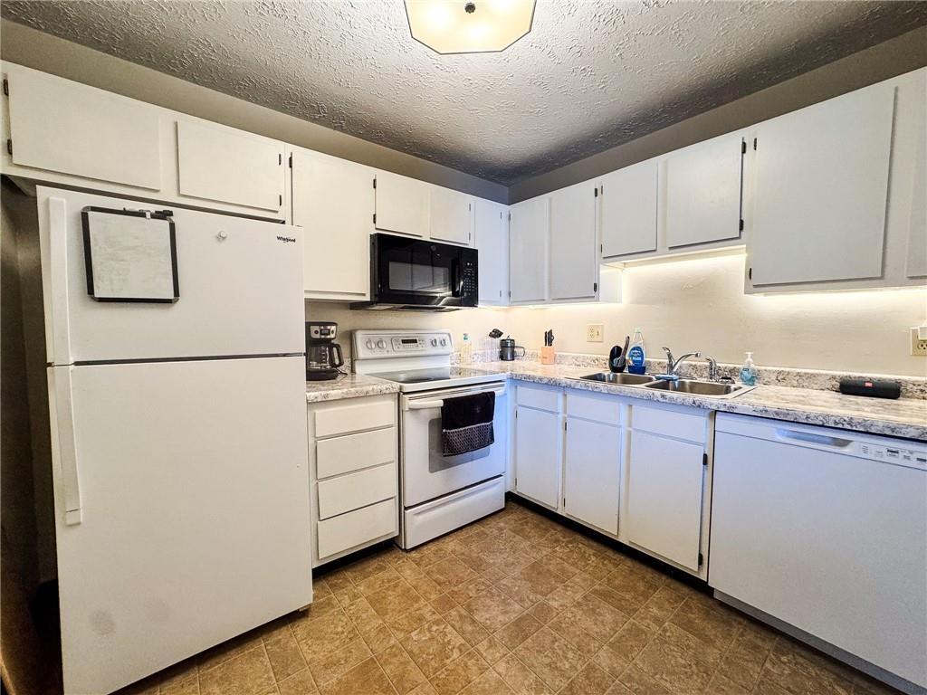 1201 Dutilh Road, Unit 12 Cranberry Township, PA 16066 - Photo 7 of 19 a kitchen with cabinets stainless steel appliances and a counter