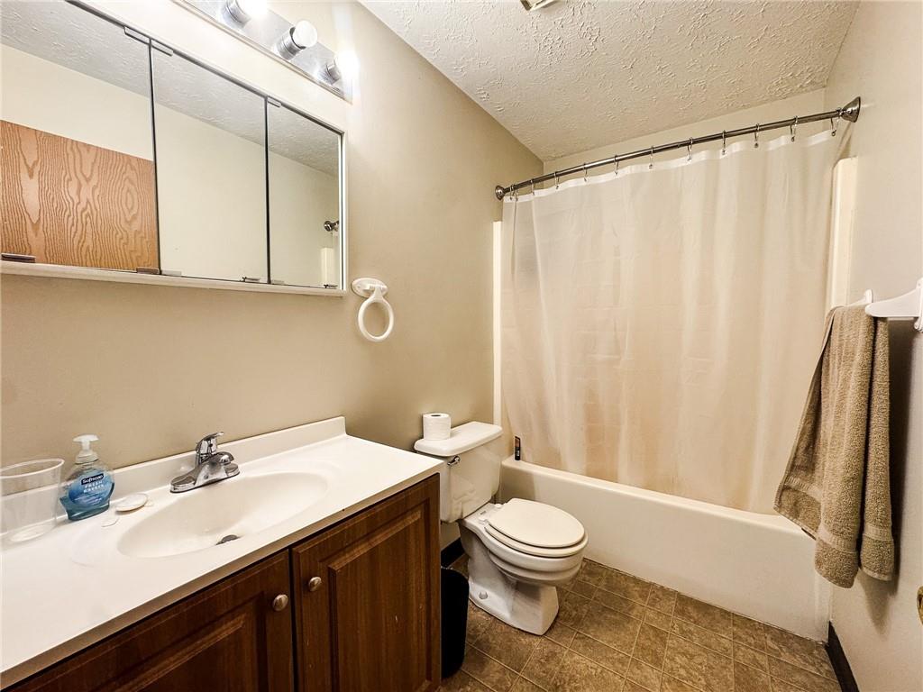 1201 Dutilh Road, Unit 12 Cranberry Township, PA 16066 - Photo 9 of 19 a bathroom with a sink a toilet and a mirror