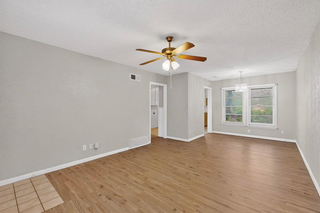 4508 Rutland Avenue Fort Worth, TX 76133 - Photo 8 of 36 a view of an empty room with a window and a fan