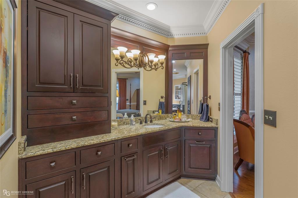 195 Tanglewood Road Homer, LA 71040 - Photo 17 of 37 a bathroom with a granite countertop sink mirror and cabinets