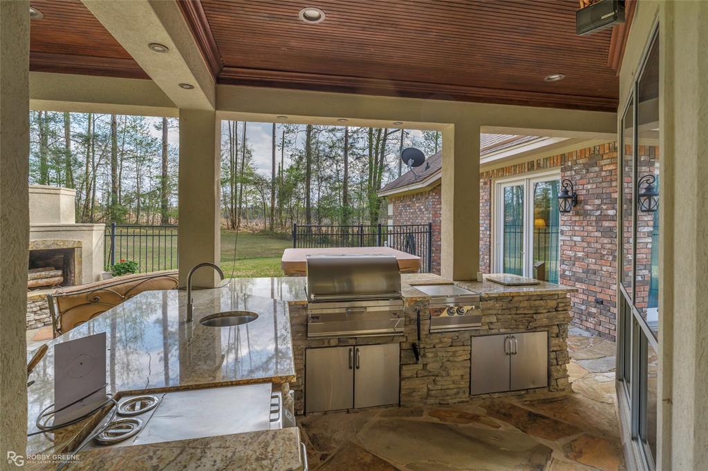195 Tanglewood Road Homer, LA 71040 - Photo 25 of 37 a open kitchen with granite countertop a stove top oven a sink and glass door