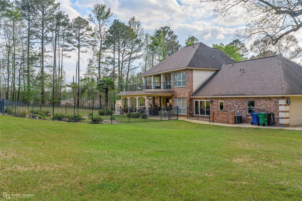 195 Tanglewood Road Homer, LA 71040 - Photo 31 of 37 a view of a house with a big yard and large trees