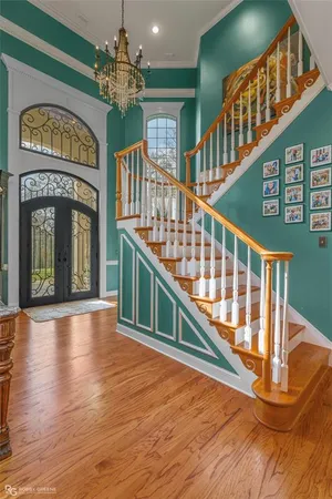 a view of an entryway with a floor to ceiling window and a chandelier