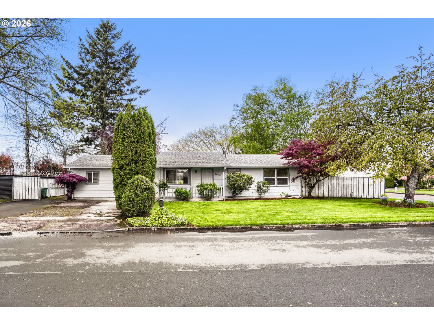 1675 Northeast Juniper Avenue Gresham, OR 97030 - Photo 1 of 29 a front view of a house with a yard and garage
