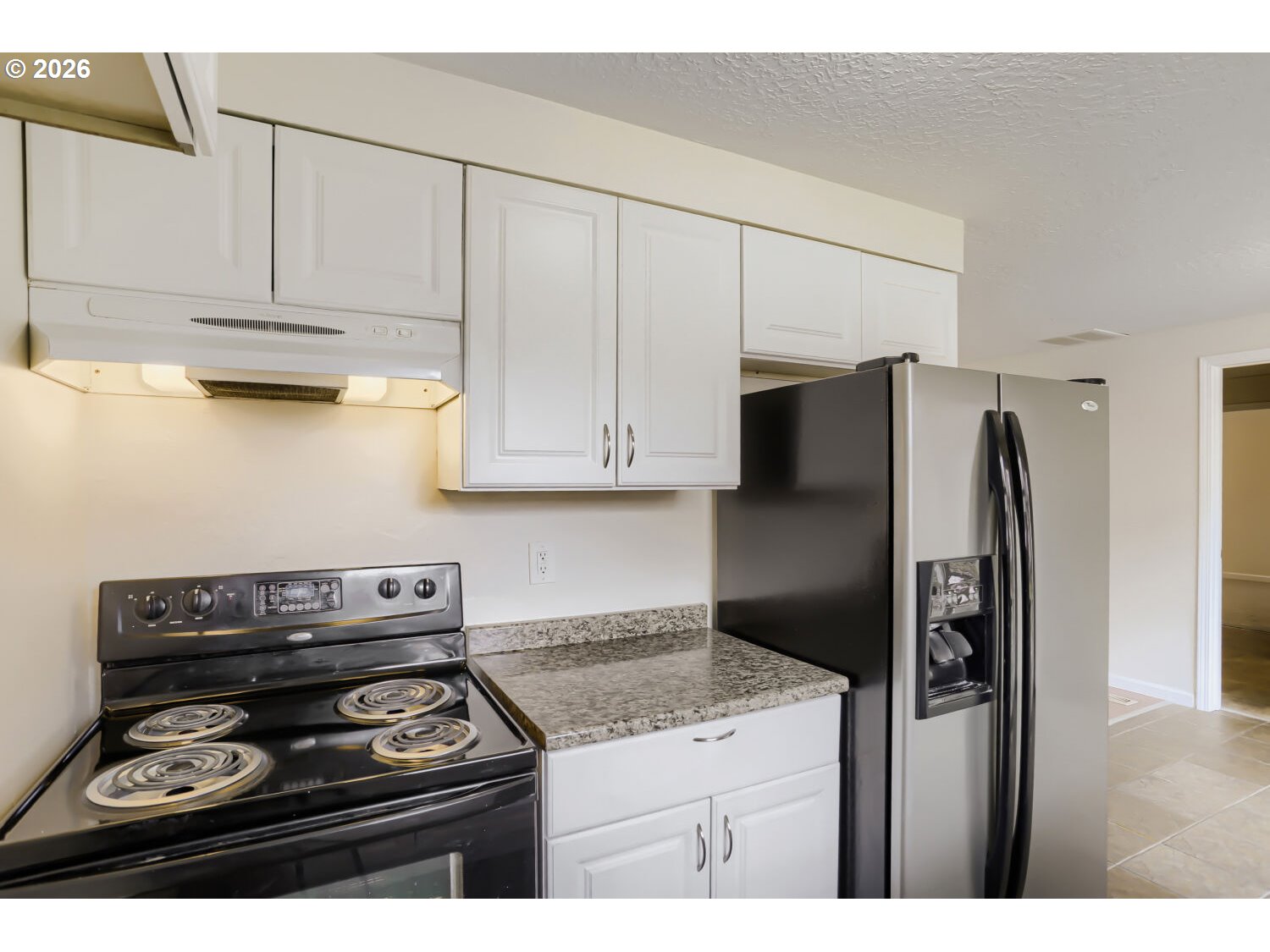 1675 Northeast Juniper Avenue Gresham, OR 97030 - Photo 11 of 29 a kitchen with stainless steel appliances granite countertop a stove a refrigerator and a cabinets