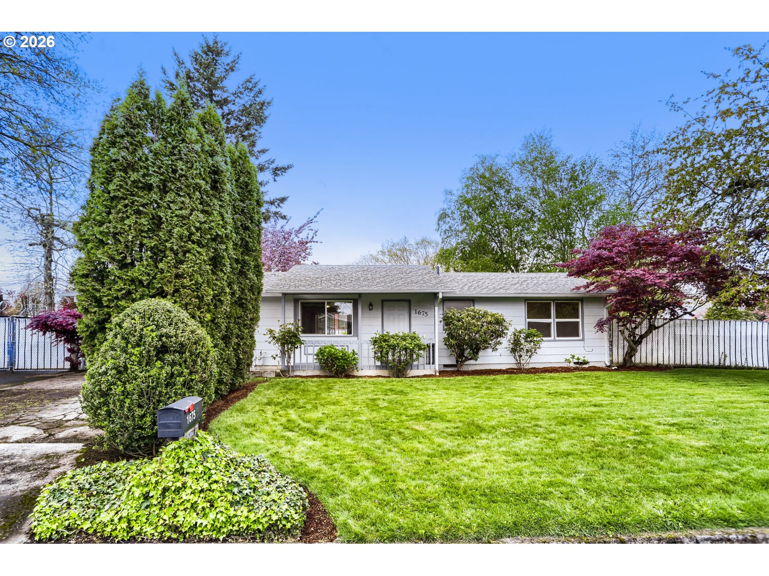 1675 Northeast Juniper Avenue Gresham, OR 97030 - Photo 3 of 29 a front view of a house with a garden