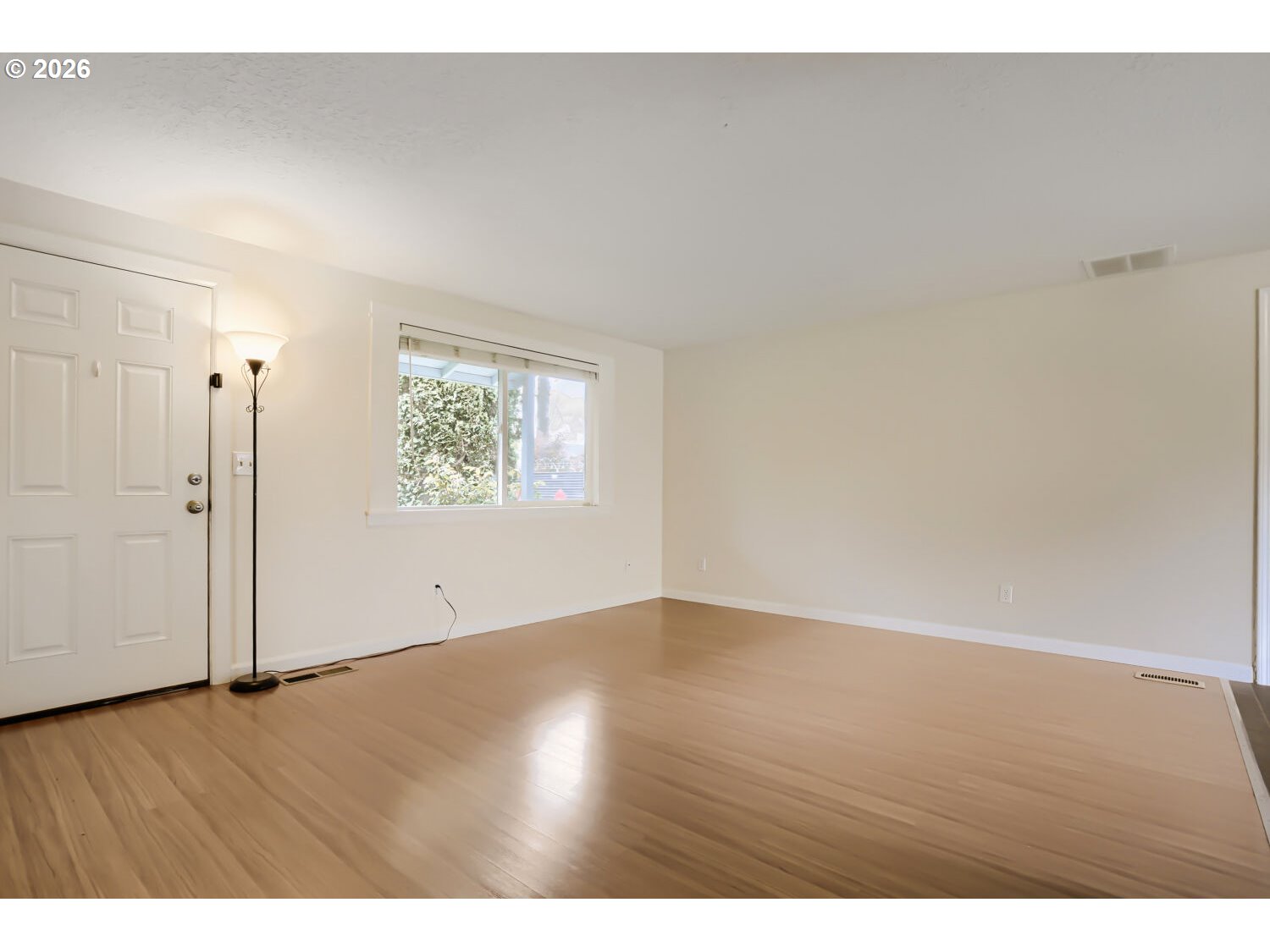 1675 Northeast Juniper Avenue Gresham, OR 97030 - Photo 5 of 29 a view of an empty room with wooden floor and a window