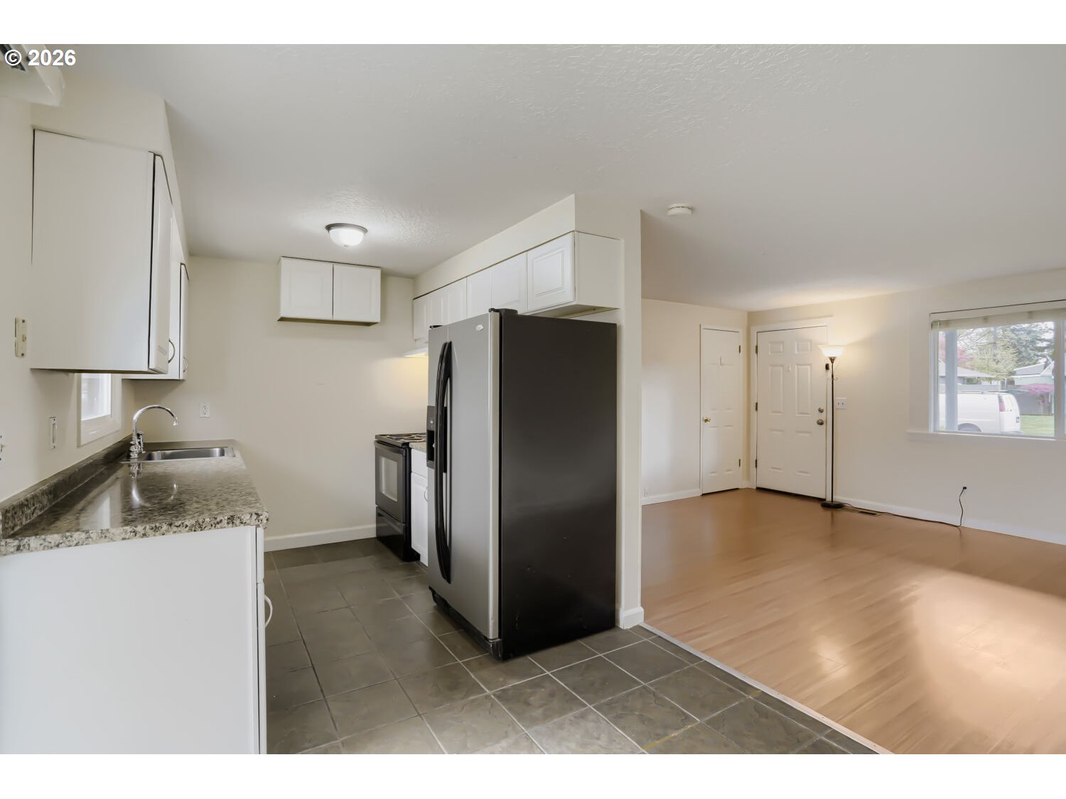 1675 Northeast Juniper Avenue Gresham, OR 97030 - Photo 9 of 29 a kitchen with a refrigerator and a sink