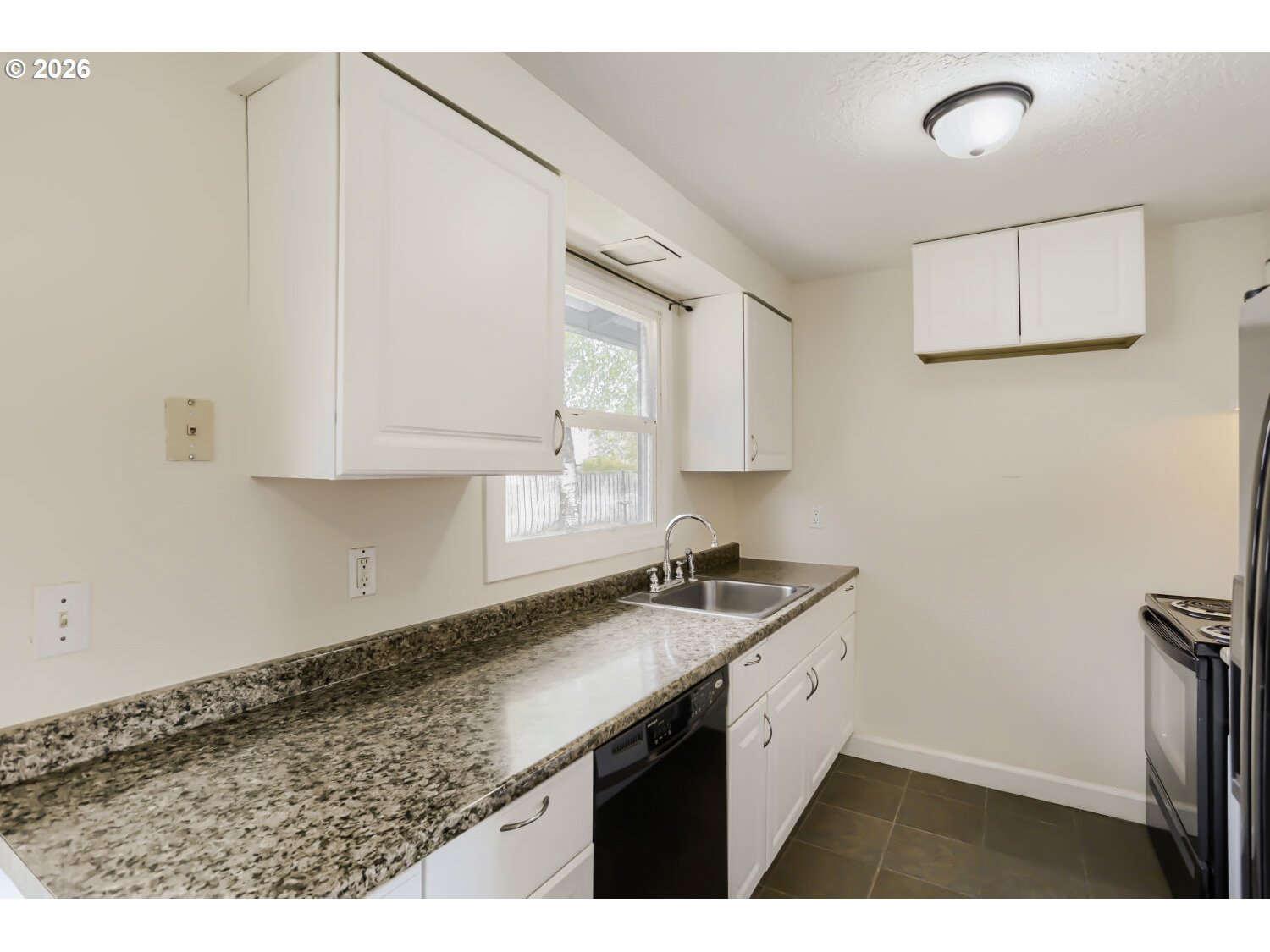 1675 Northeast Juniper Avenue Gresham, OR 97030 - Photo 10 of 29 a kitchen with a sink cabinets and a window