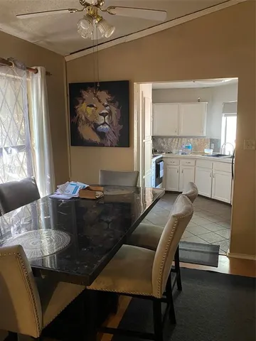 a living room with stainless steel appliances kitchen island granite countertop furniture and a fireplace