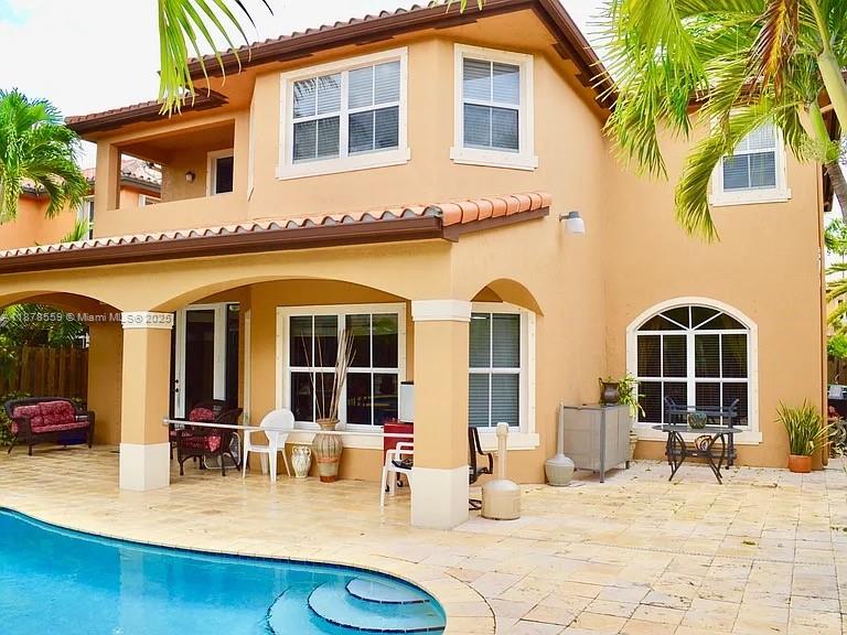 15601 Southwest 31st Lane Miami, FL 33185 - Photo 14 of 18 a view of a house with patio