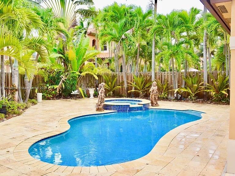 15601 Southwest 31st Lane Miami, FL 33185 - Photo 15 of 18 a view of swimming pool with lawn chairs and plants