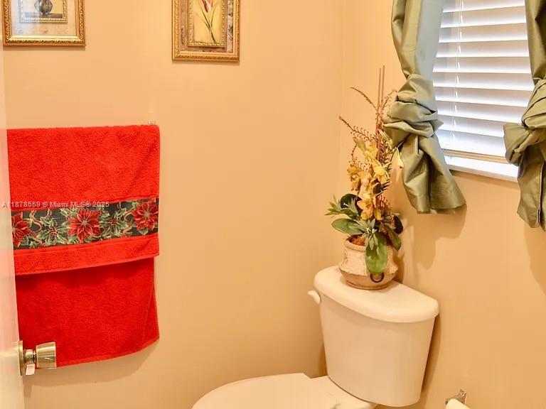 15601 Southwest 31st Lane Miami, FL 33185 - Photo 8 of 18 a bathroom with a toilet and a mirror