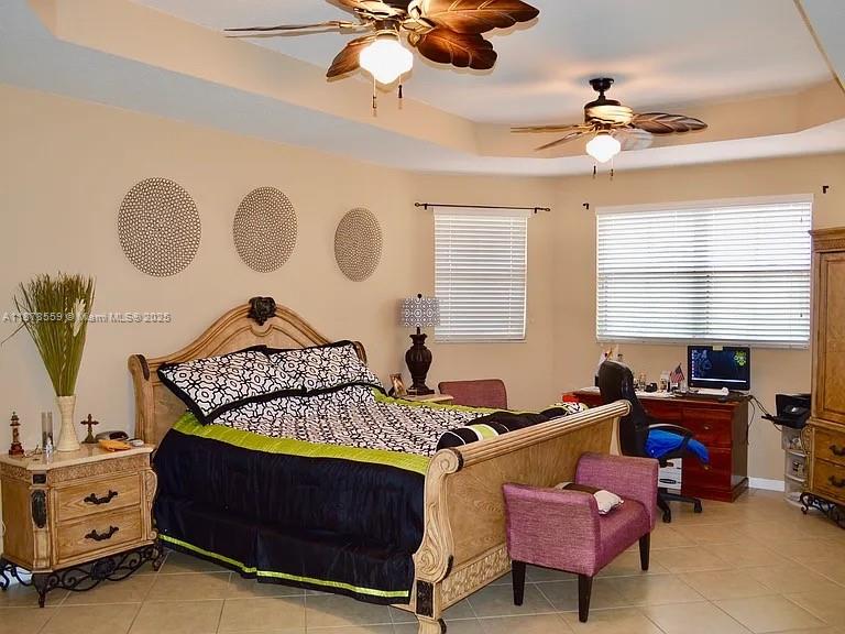 15601 Southwest 31st Lane Miami, FL 33185 - Photo 9 of 18 a bedroom with a bed and a chandelier