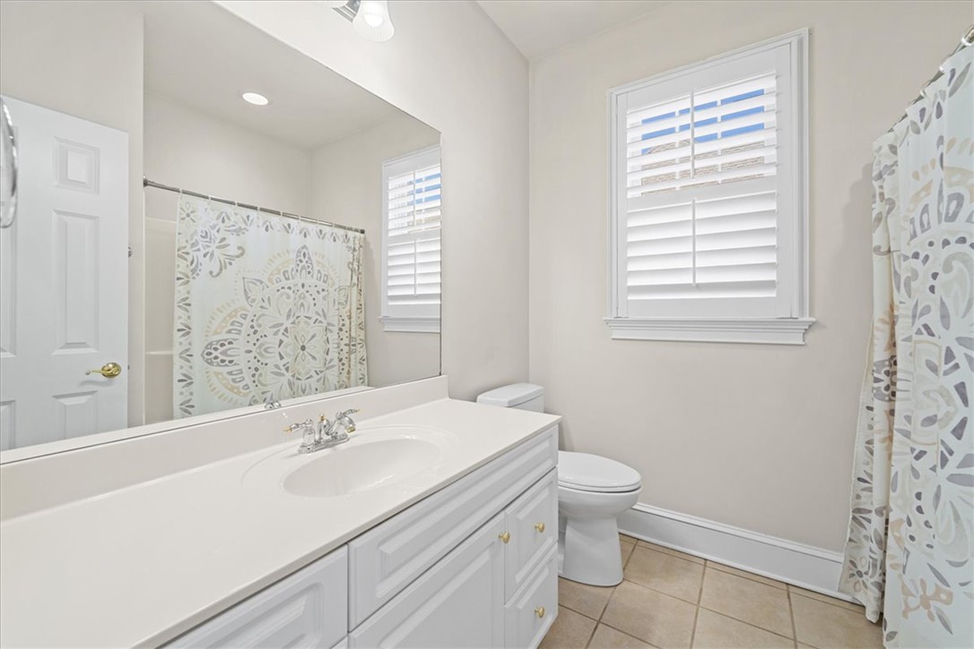 38 Angus Run Seneca, SC 29672 - Photo 20 of 46 This bathroom features elegant white cabinetry with a spacious counter and tiled flooring.