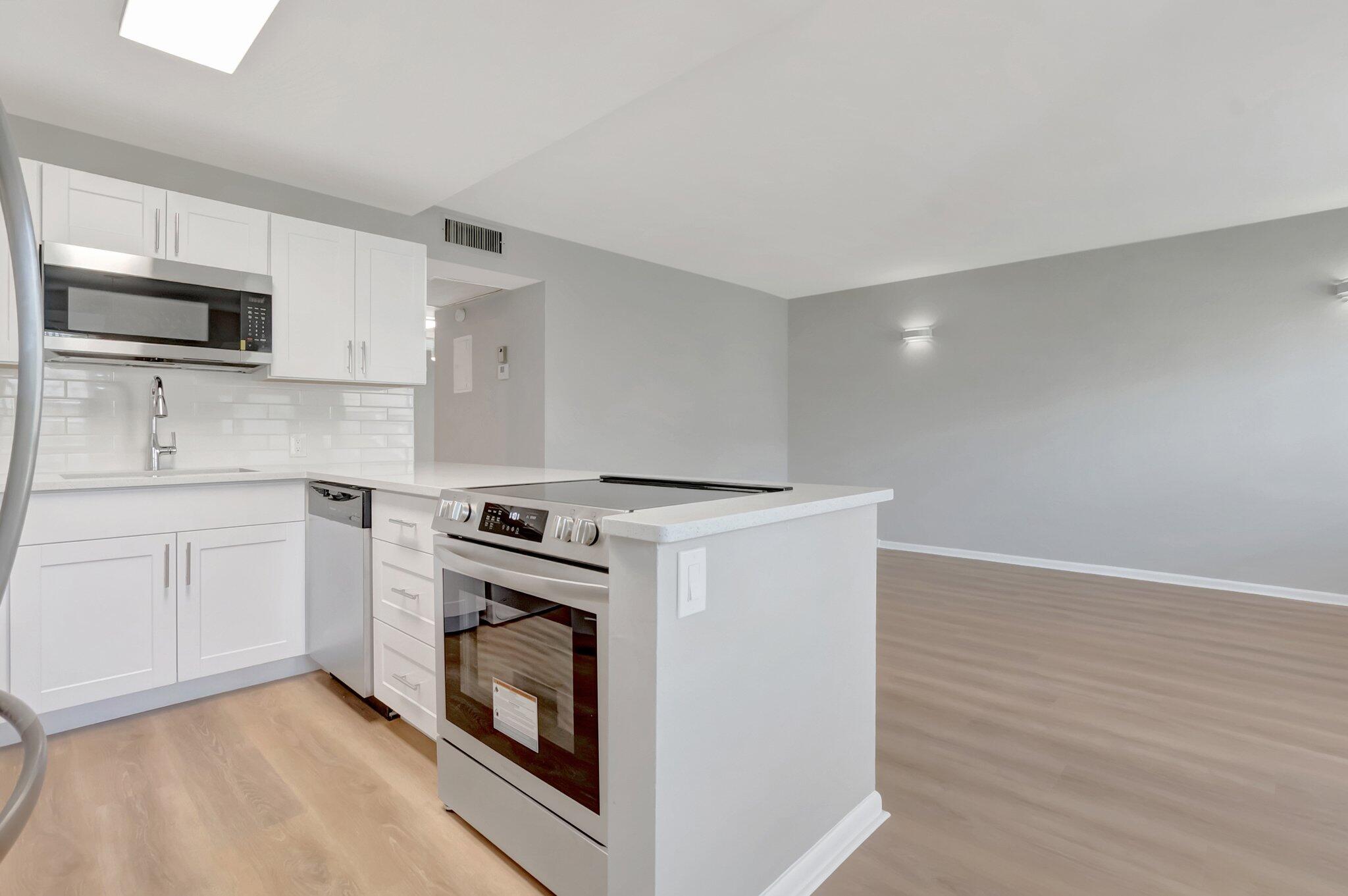 296 Fanshaw H Boca Raton, FL 33434 - Photo 3 of 59 a kitchen with a stove top oven and sink