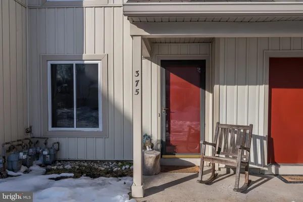 a front view of a house with outdoor seating