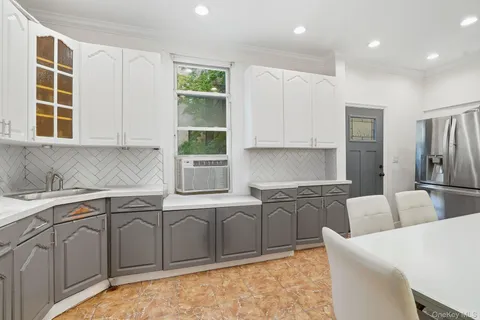 a kitchen with stainless steel appliances granite countertop a sink a stove and a refrigerator