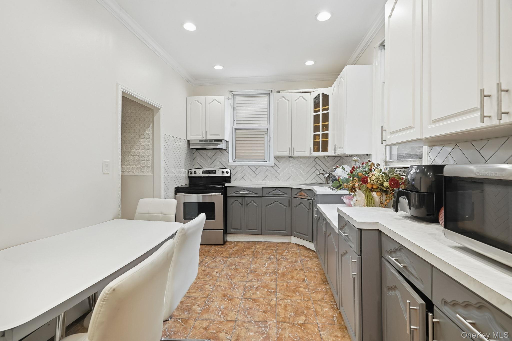 3340 Perry Avenue Bronx, NY 10467 - Photo 12 of 42 a kitchen with a sink stove and refrigerator
