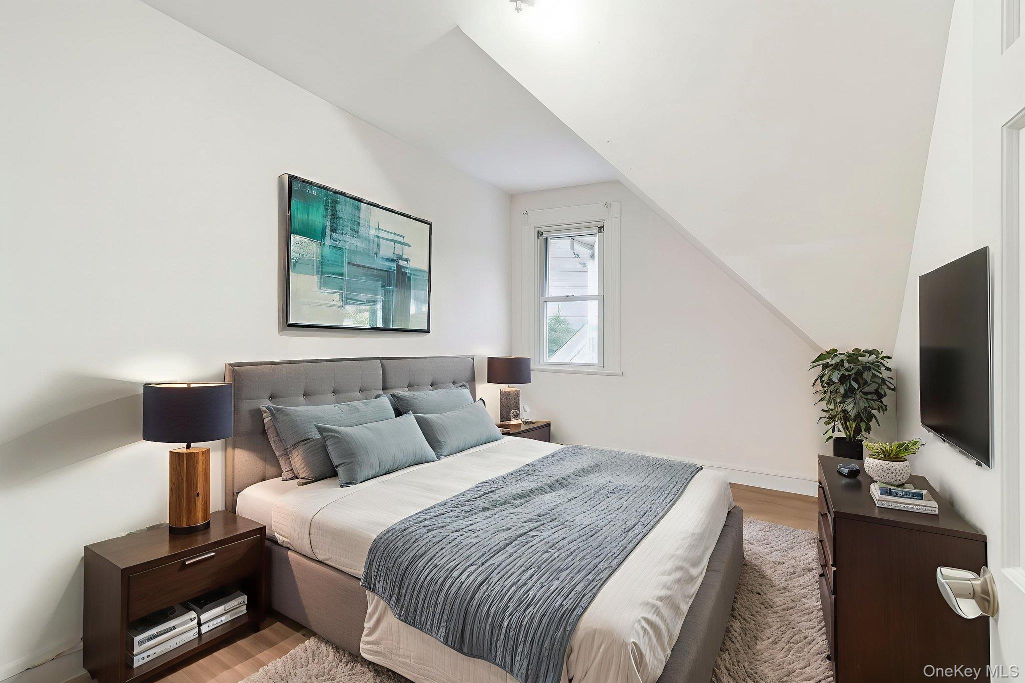 3340 Perry Avenue Bronx, NY 10467 - Photo 19 of 42 a bedroom with a bed and a flat screen tv