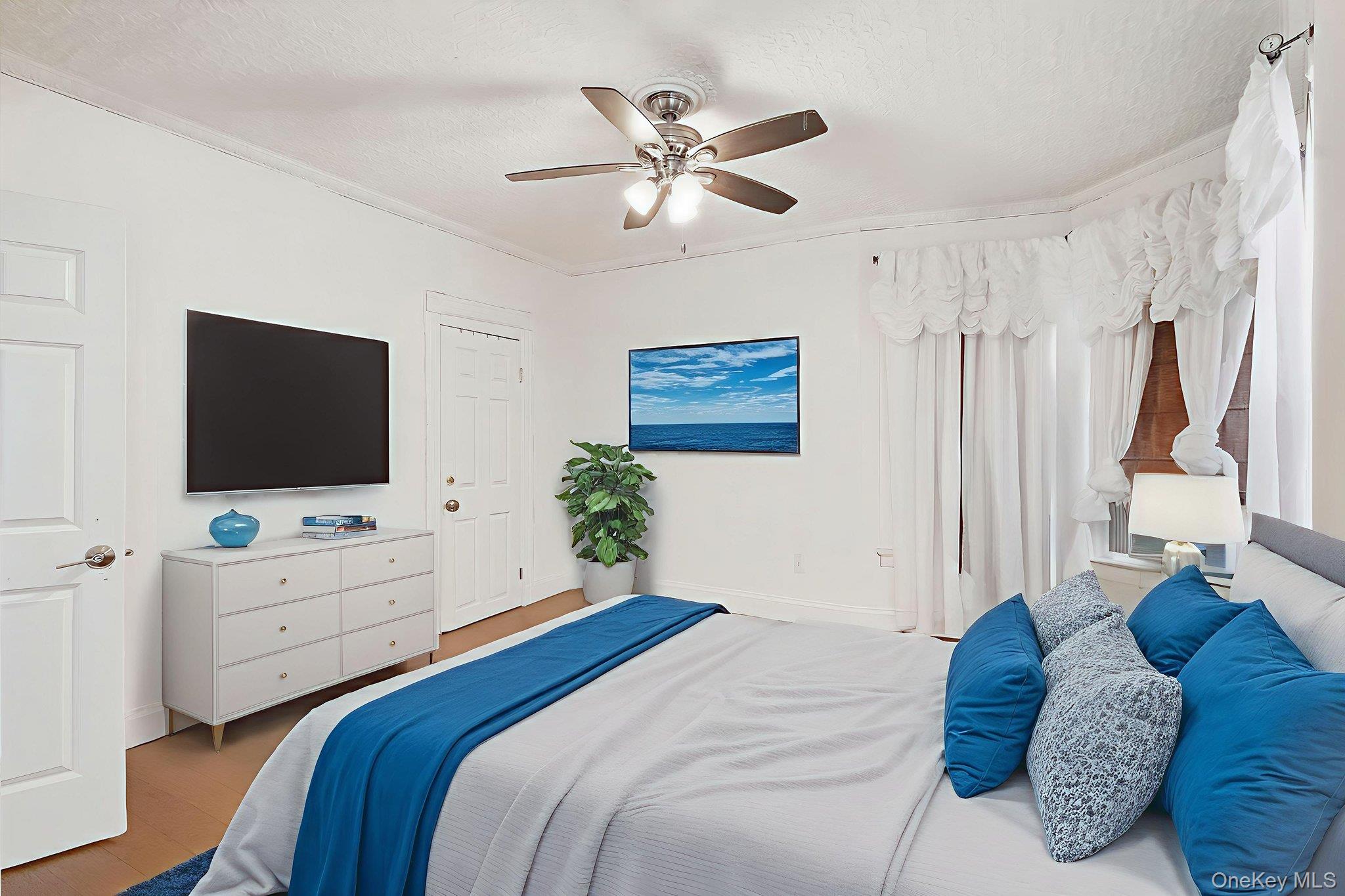 3340 Perry Avenue Bronx, NY 10467 - Photo 21 of 42 a bedroom with a bed and a flat screen tv