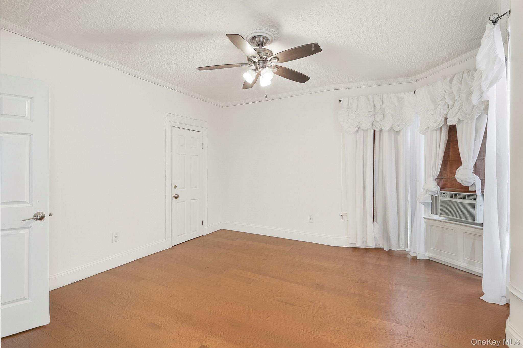 3340 Perry Avenue Bronx, NY 10467 - Photo 23 of 42 a view of empty room with ceiling fan