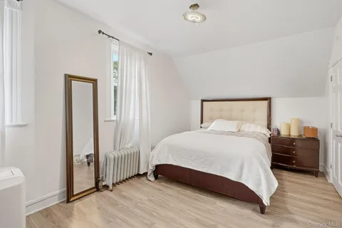 a bedroom with a bed and a mirror