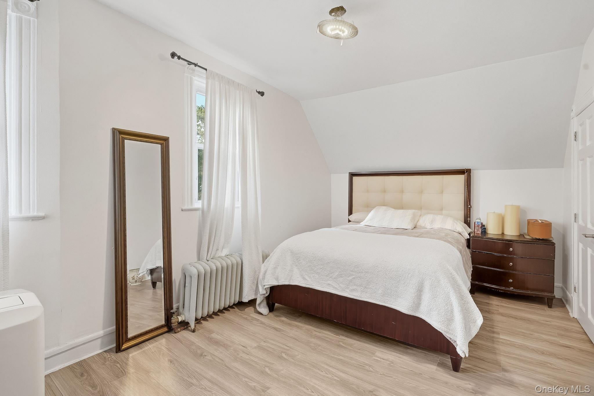 3340 Perry Avenue Bronx, NY 10467 - Photo 24 of 42 a bedroom with a bed and a mirror