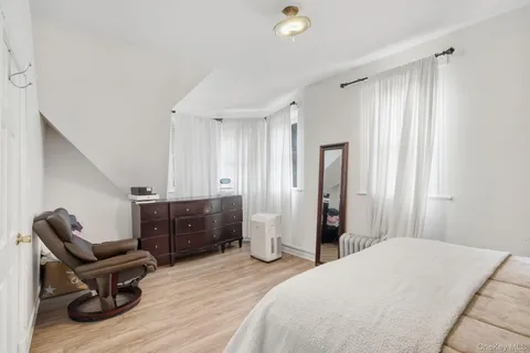 a bedroom with furniture and a wooden floor