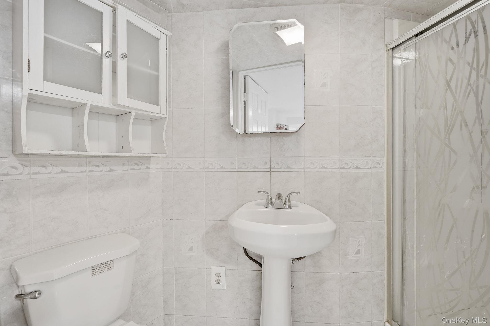 3340 Perry Avenue Bronx, NY 10467 - Photo 29 of 42 a bathroom with a sink toilet and mirror