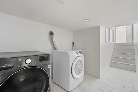 a view of storage and utility room with washer and dryer