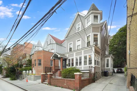 a front view of a residential apartment building with a yard
