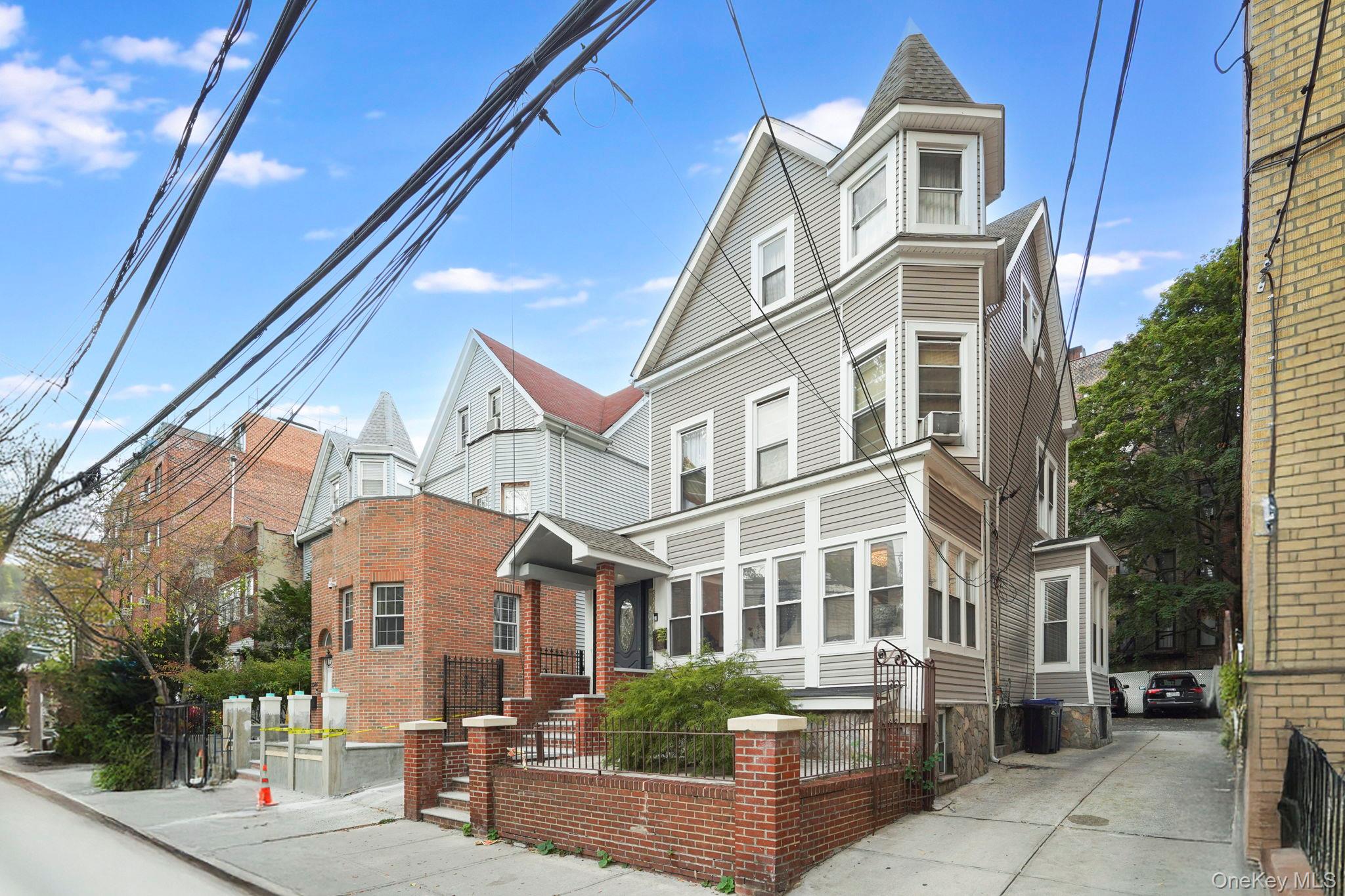 3340 Perry Avenue Bronx, NY 10467 - Photo 33 of 42 a front view of a residential apartment building with a yard