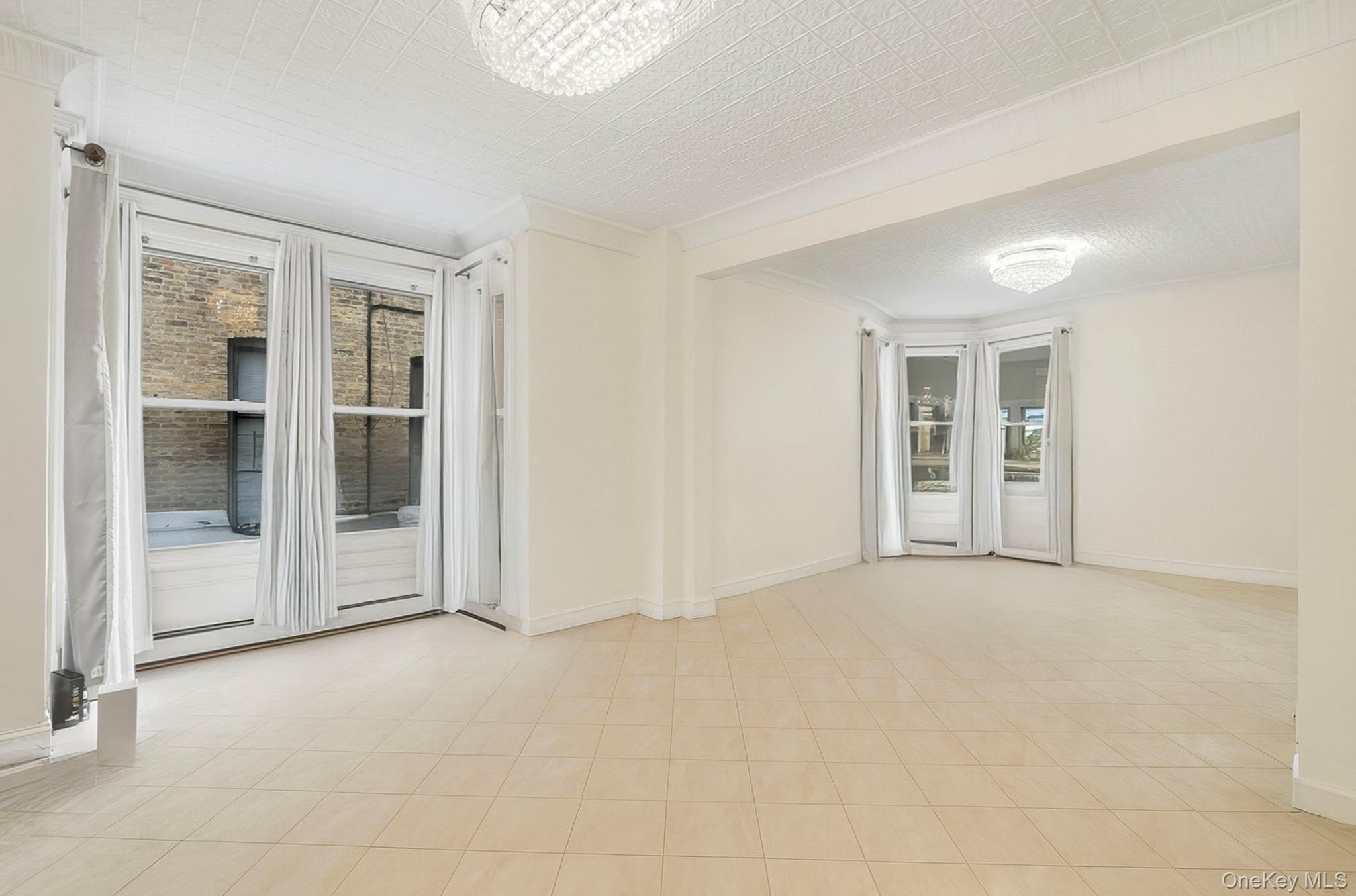 3340 Perry Avenue Bronx, NY 10467 - Photo 9 of 42 an empty room with windows