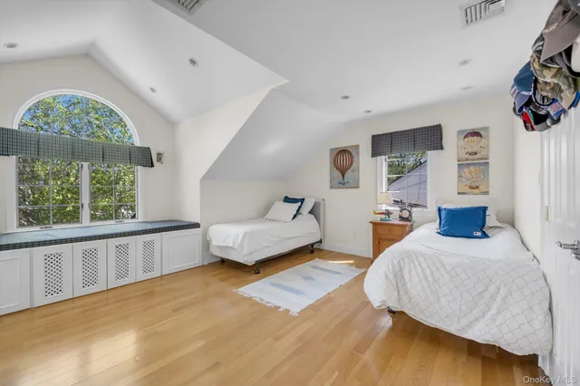 a bedroom with furniture and a large window