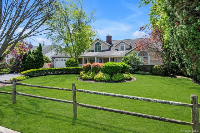 a front view of a house with a yard table and chairs
