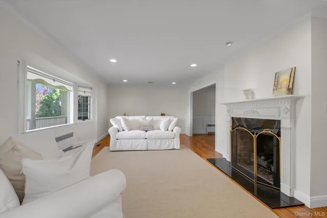 a living room with furniture a large window and a fireplace