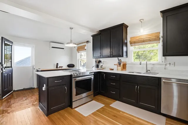 a kitchen with stainless steel appliances granite countertop a sink stove and refrigerator