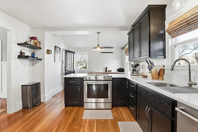 a kitchen with sink cabinets and wooden floor