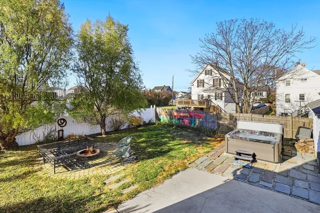 a view of a chairs and table in the backyard