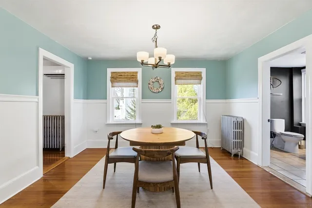 a view of a dining room with furniture and wooden floor
