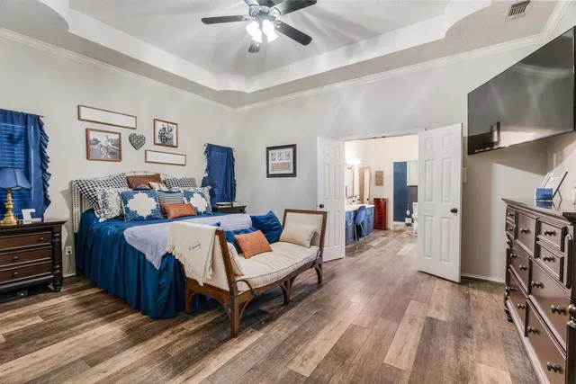 a bedroom with furniture and a chandelier